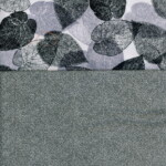 Textile design with large, detailed dark leaves on top and a small, intricate leaf pattern on the bottom.