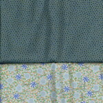 Fabric with two patterns: top has a teal background with small circles, and bottom features lollipop motifs on a colorful grid.