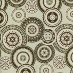 Circular geometric patterns in shades of black, white, and green overlap on a light green background.