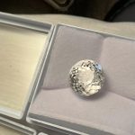 Round clear gemstone displayed in a gray padded box with an open lid at Creative Craftworks