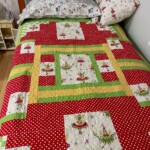 Colorful patchwork quilt with fairytale designs on a bed with wooden headboard, accompanied by a matching pillow.